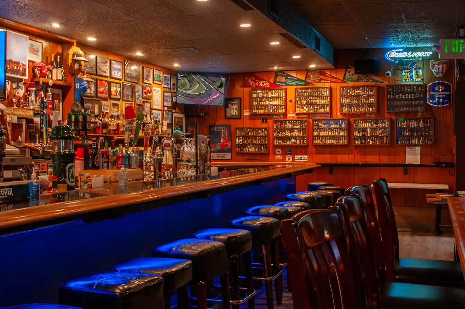 View of Bar with Signed Race Photos and Mini Liquor Bottles Thumbnail